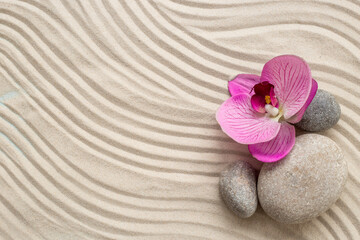 Fototapeta na wymiar Zen garden meditation sandy background with stones for relaxation and hatmony