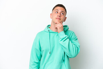 Fototapeta premium Young brazilian man isolated on white background having doubts