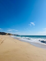 Fototapeta na wymiar Ocean bay, rocky ocean coast, sandy beach, blue sky