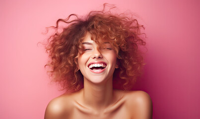 Radiant woman with curly hair laughs heartily.