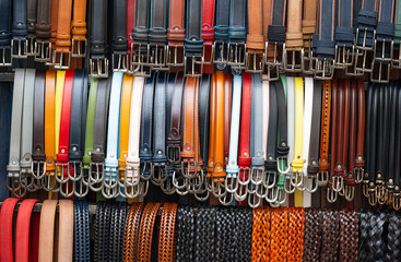 many leather belts on the market - obrazy, fototapety, plakaty