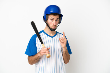 Young caucasian man playing baseball isolated on white background thinking an idea pointing the finger up