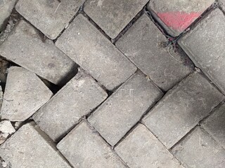 Damaged paving blocks. The damaged paving block road is bumpy
