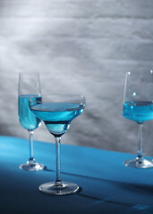 Glasses with blue alcohol cocktail ready for a party	