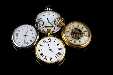 Selection of Pocket Watches on a Black Reflective Surface - 670034034