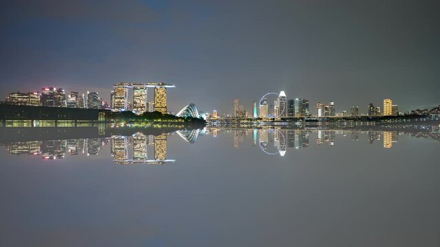 4k time lapse of sunset day to night scene at Marina Bay Singapore city skyline with reflection effect. 