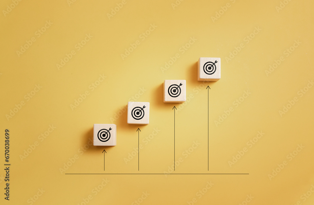 Poster wooden block with target icon and arrow aim to target on orange background for business achievement 