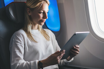 Fototapeta premium Tourist woman use wireless connection on board