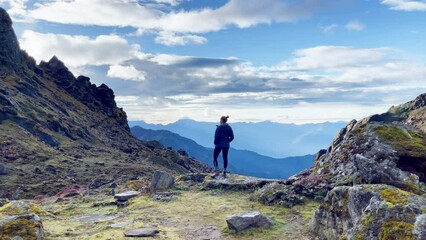Lonely female enjoying Himalaya mountains Makalu Barun Park trekking route in Tulikharka 4100m. Mera peak climbing acclimatization walk. Active healthy life, traveling, sport mount climbing 4K video.
