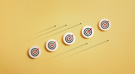 wooden block with target icon and arrow aim to target on orange background for business achievement...