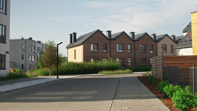No people establishing shot of empty street with modern houses in suburban area on summer morningNo people establishing shot of empty street with modern houses in suburban area on summer morningNo peo