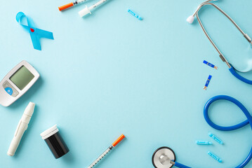 Show support during Diabetes Awareness Month. Top-view shot of the diabetes emblem - blue ribbon, glucometer, lancet pen, needles, insulin syringe, stethoscope on soft blue backdrop. Space for message