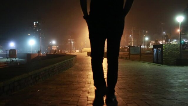 Man walking on the Port Elizabeth beach front at night
