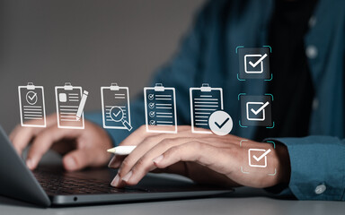 Businessman using laptop with document online for approve quality assurance and ERP management,...