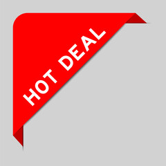 Red color of corner label banner with word hot deal on gray background