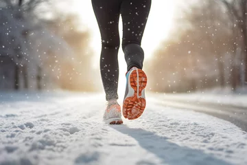 Foto op Plexiglas Back view of woman's legs with sport shoes jogging in snow © Firn