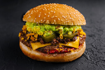veggie burger with guacamole and pickles on toasted bun