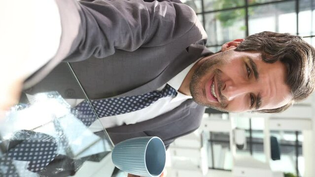 Portrait of a businessman drinking coffee in a modern office