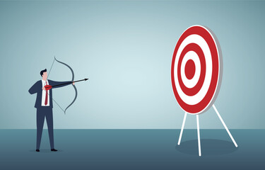 Focus on business goal, reaching target or achievement, achieve business objective or purpose, motivation to success concept, confidence businessman holding arch shooting to dartboard bullseye.