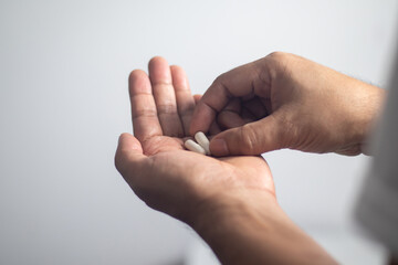 Male hands holding pills for treat illness