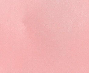 A light pastel pink textured background with a rough, uneven surface