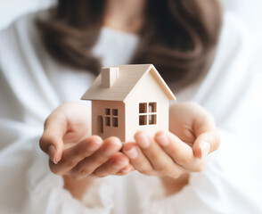 Houses and money, property management, house buying, house price changes, woman holding house model