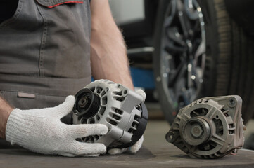 Repair and maintenance in a car service. An auto mechanic performs work to replace a faulty...