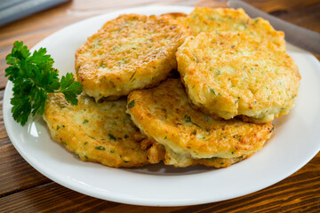 cooked fried potato cutlets with herbs