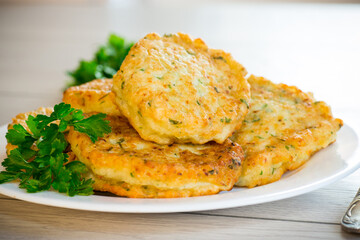 cooked fried potato cutlets with herbs