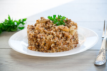 cooked buckwheat boiled with mushroom filling in a plate