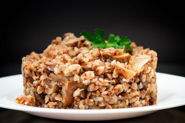 cooked buckwheat boiled with mushroom filling in a plate