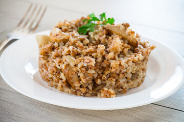 cooked buckwheat boiled with mushroom filling in a plate