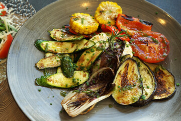 Close up assorted grilled vegetables- Courgette zucchini, corn, tomatoes, eggplants and Brussels sprouts