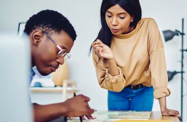 Male and female colleagues concentrated on planning route for exploring spending time together