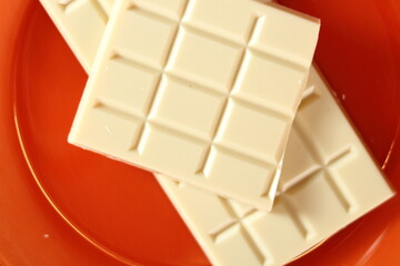 Bar of white chocolate. Making frozen strawberry cheesecake series.