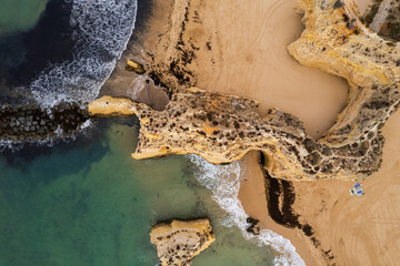 Aerial drone view of  sandy beach of Praia da Rocha and Atlantic Ocean waves, Algarve,Portugal