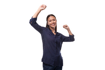 young caucasian fashionable brunette woman dressed in a dark blue blouse actively gesticulates