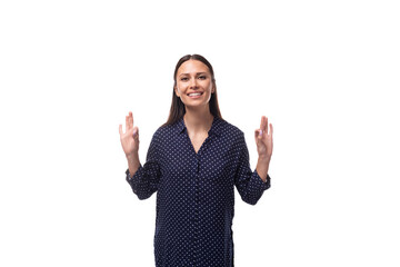young brunette advertiser woman dressed in a blue blouse with a pattern of peas gesturing with her...