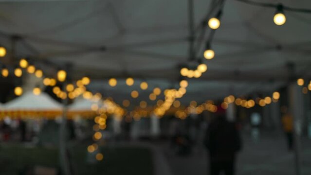 Christmas blurred background, backyard illumination, light in the evening city street, electric lanterns with round diffuser. 