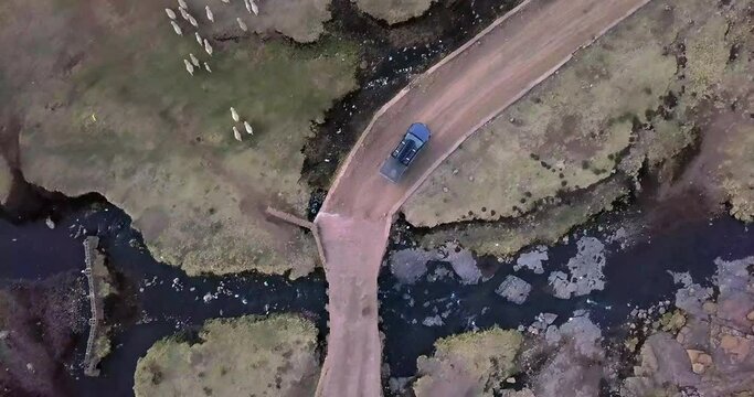 Car road trip, sheep and drone aerial view of Greece countryside, rural environment or agriculture with animal livestock. Nature landscape, lamb and travel van, truck or vehicle on transport route