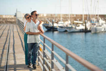 Fototapeta premium Mature spouses enjoying embrace near ships and yachts at marina