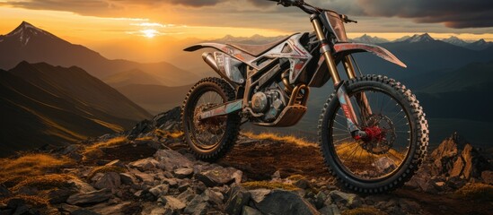 professional trail rider in full equipment riding dirt bike on mountain road at sunset