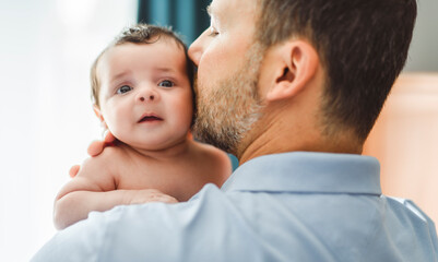 father on bedroom with his newborn baby son