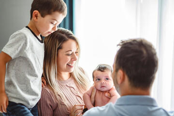 family on bedroom with his newborn baby son