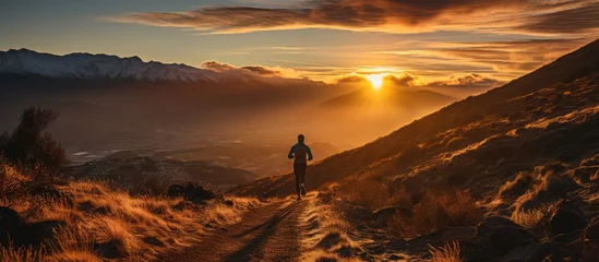 Fotobehang Trail Runner running on the mountain, at sunrise © Almahyra