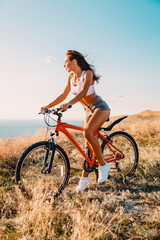 Sporty attractive woman with mountain bicycle in outdoor. Lifestyle with young lady.