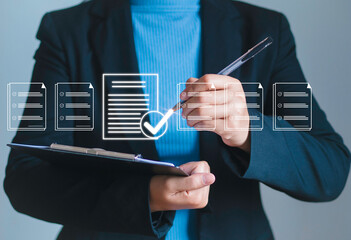 Business performance checklist concept Businessman surveys checklist online Businessman uses a pen...