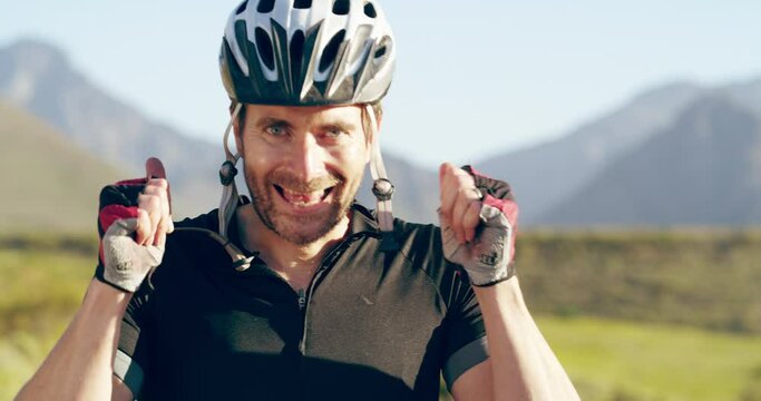 Face, thumbs up and a man cycling in the mountains for fitness, health or wellness during summer. Portrait, smile and bike with a happy athlete outdoor for success, support or exercise motivation