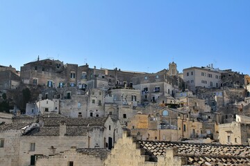 caves carved in the rocks, remains of an ancient city, a hill with carved pits, a rock mountain, Matera, Basilicata, Italy