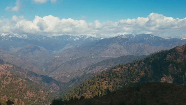 Aerial view of a beautiful valley of mountains in Uttarakhand, India during winter. rocky mountains and cloudy sky. Adventure in India.